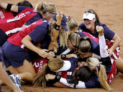 
U.S. players pile onto pitcher Lisa Fernandez after their win over Australia in the gold medal game Monday. 
 (Associated Press / The Spokesman-Review)