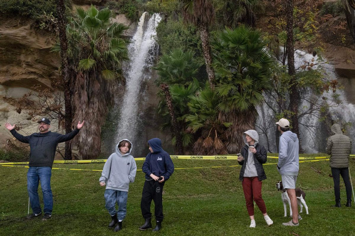 Runoff storm water creates a powerful waterfall near Dana Point Harbor on Tuesday, Feb. 6, 2024. Dozens of people did not let the rain stop them from looking at it up close.    (Mindy Schauer/Orange County Register/TNS)