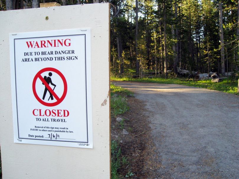The bridge to the southern rim of one of Yellowstone National Park's top attractions, the Grand Canyon of the Yellowstone River, is shown closed Wednesday. Park officials closed this area after a grizzly sow killed a man who was hiking with his wife a mile and a half up the trail the day before.  (Associated Press)