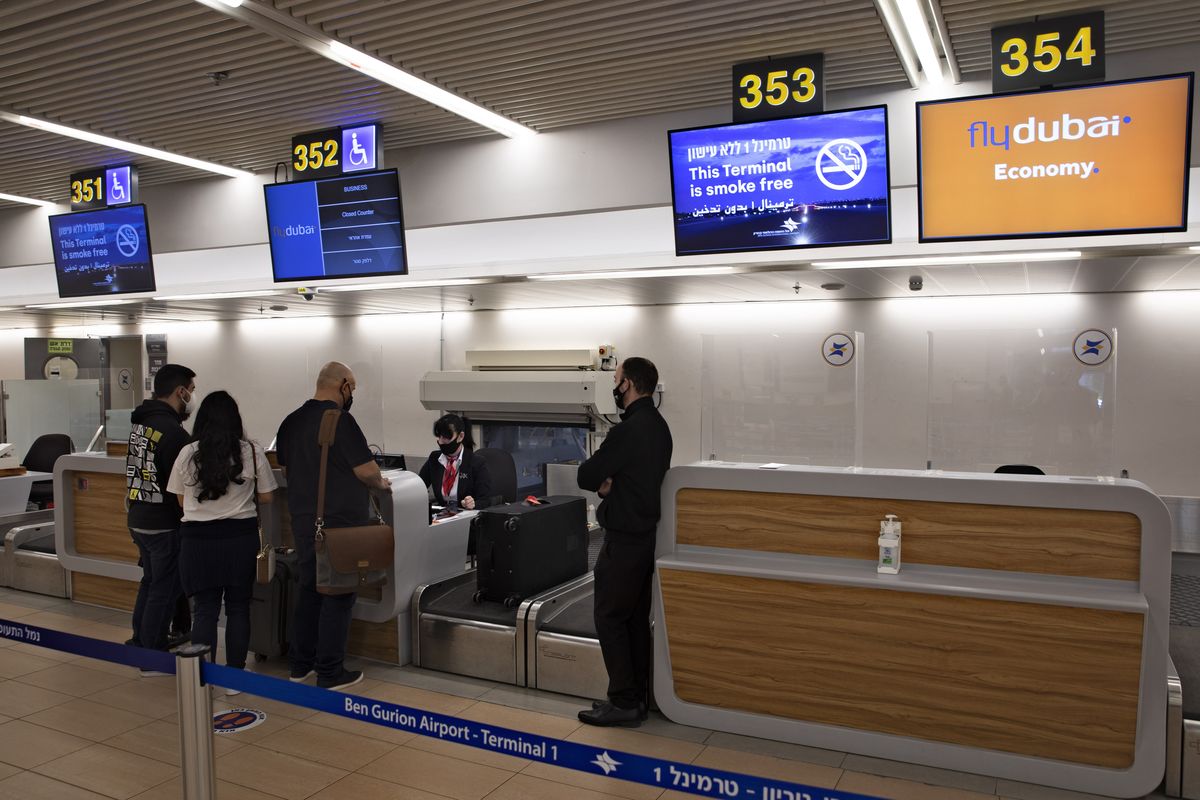 Israelis prepare to fly to Dubai at the Ben Gurion airport near Tel Aviv, Israel, Thursday, Dec. 3, 2020. The Israeli government is urging its citizens to avoid travel to the Gulf states of the United Arab Emirates and Bahrain, citing threats of Iranian attacks. Thursday