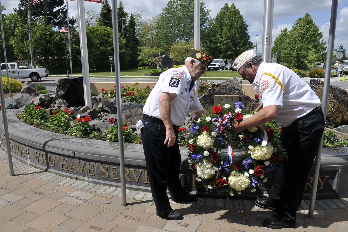 Terry Fleming, left, and Emmett Sullivan of the Veterans of Foreign Wars lay a wreath at the PFC Robert J. Gordon Veterans Memorial Plaza.