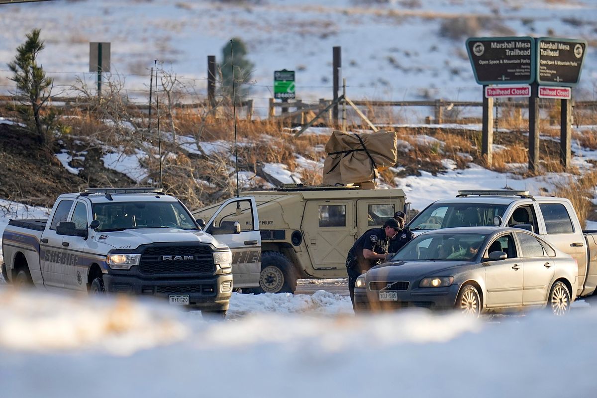 Boulder County Sheriff’s officers work a road block at the suspected origin of the Marshall wildfire Monday, Jan. 3, 2022, in Boulder, Colo.  (Jack Dempsey)