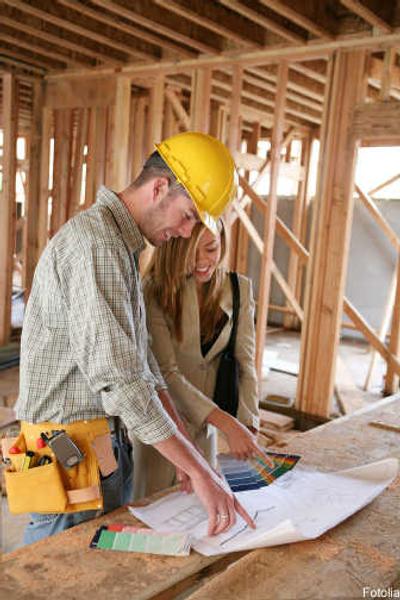 
A home designer works with a home builder, inspecting the blueprints.
 (© fotolia.com / The Spokesman-Review)