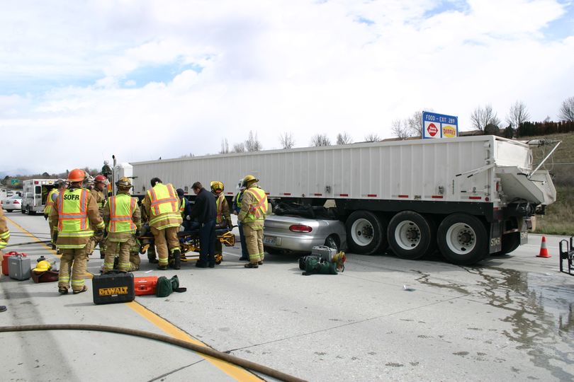 Crews work at the scene of a crash on eastbound Interstate 90 that left a sedan pinned under a tractor-trailer Tuesday, April 6, 2010. (Courtesy of Spokane Valley Fire Department)
