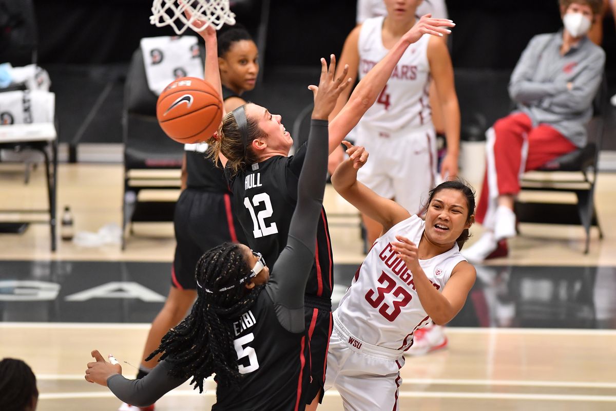 Washington State’s Cherilyn Molina passes around Stanford’s Lexie Hull (12) and Francesca Belbi on Wednesday in Pullman.  (Courtesy of WSU Athletics)