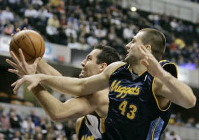 
Indiana's Jeff Foster, left, and Denver's Linas Kleiza battle for possession of a rebound.Associated Press
 (Associated Press / The Spokesman-Review)