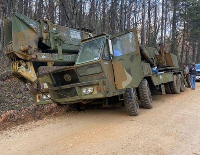 A 70-ton crane that was allegedly stolen in Alabama on March 14 is shown. A man was arrested after calling a towing service asking to have it removed from woods, authorities said.  (HOGP)