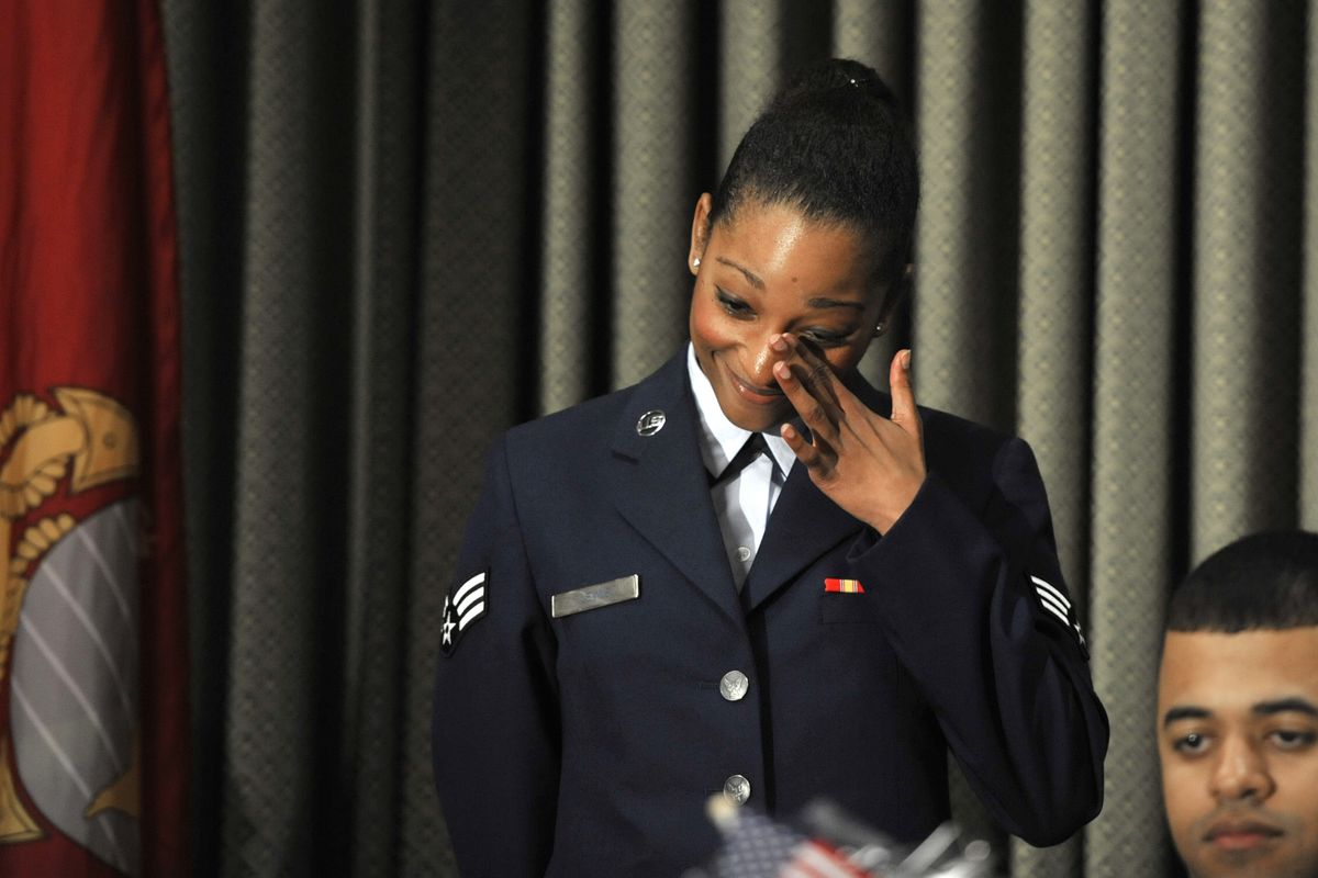U.S. Air Force Senior Airman Ariella Lewis wipes her eye as her accomplishments are read to the crowd during the 2012 Armed Forces Persons of the Year ceremony Wednesday at the Red Lion Hotel at the Park. (Dan Pelle)
