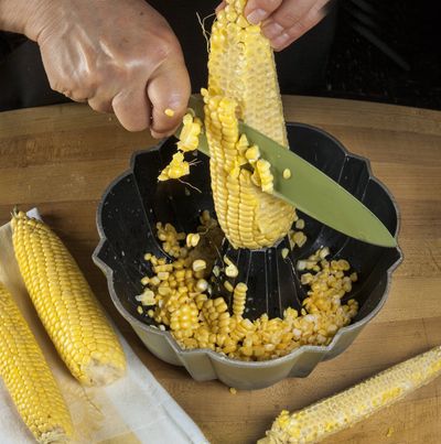 Remove the kernels from a cob of corn with the help of a Bundt pan.