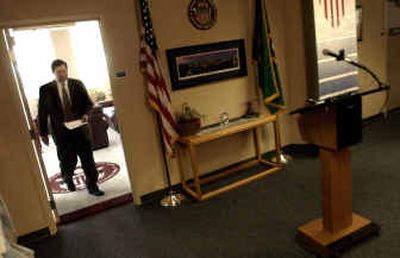 Spokane Mayor Jim West walks from his office to a podium to apologize for his