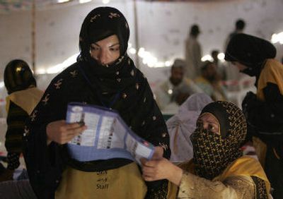 
A worker looks at a ballot paper at a counting center in Kandahar, Afghanistan, Tuesday. Afghanistan continues the long process of collecting and counting votes Tuesday, two day after landmark legislative elections. 
 (Associcated Press / The Spokesman-Review)