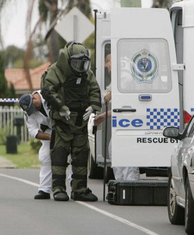 
A police officer puts on protective gear as he prepares to inspect a suspicious package in Sydney, Australia. 
 (Associated Press / The Spokesman-Review)
