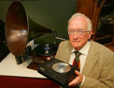 
Pieter Kramer poses for photographers in Eindhoven, Netherlands, last week. Kramer was a leading engineer on the team that developed the CD, which was launched 25 years ago this Friday, in a joint project by Royal Philips Electronics NV and Sony Inc. of Japan. Kramer is holding a show model of the compact disc player, which was introduced in August 1982. Associated Press
 (Associated Press / The Spokesman-Review)