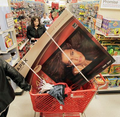 A customer pulls a cart with a flat-screen television and other items during the traditional Black Friday shopping day at a Target store in  Ohio.  (Associated Press)