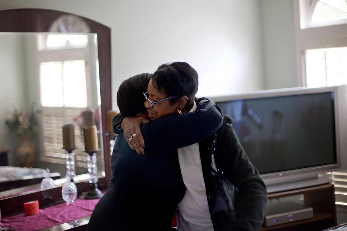 Retired Atlanta police Det. Jaqueline Barber, right, is embraced by former co-worker Robyn Anderson in the home Barber shares with her daughter and four grandchildren Monday, Oct. 8, 2012, in Fayetteville, Ga. Less than a year after Occupy Atlanta members clashed with police in riot gear in a downtown park, they're now protesting alongside officers to help Barber avoid losing her home to foreclosure. Barber said she is under threat of eviction after her medical bills mounted, partly because of a diagnosis of multiple myeloma, a form of blood cell cancer. If she's evicted, she expects that she will be homeless. (David Goldman / Associated Press)