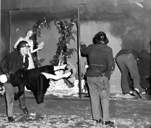 Firemen haul mannequins from a display window at Savon's Store, W801 Riverside, which was destroyed by fire December 19, 1957.  (Photo Archive / The Spokesman Review)