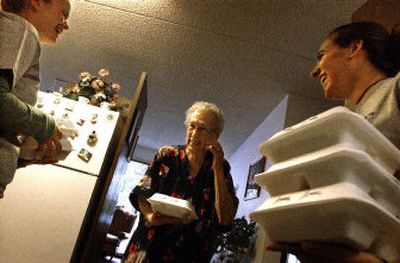 
Marie Jennings shares a laugh with Gonzaga students and volunteers with Campus Kitchen, Katie Collins, left, and Jessie Hallerman on Monday at the O'Malley Senior Apartments where they deliver food to seniors. 
 (Jed Conklin/The Spokesman Review / The Spokesman-Review)