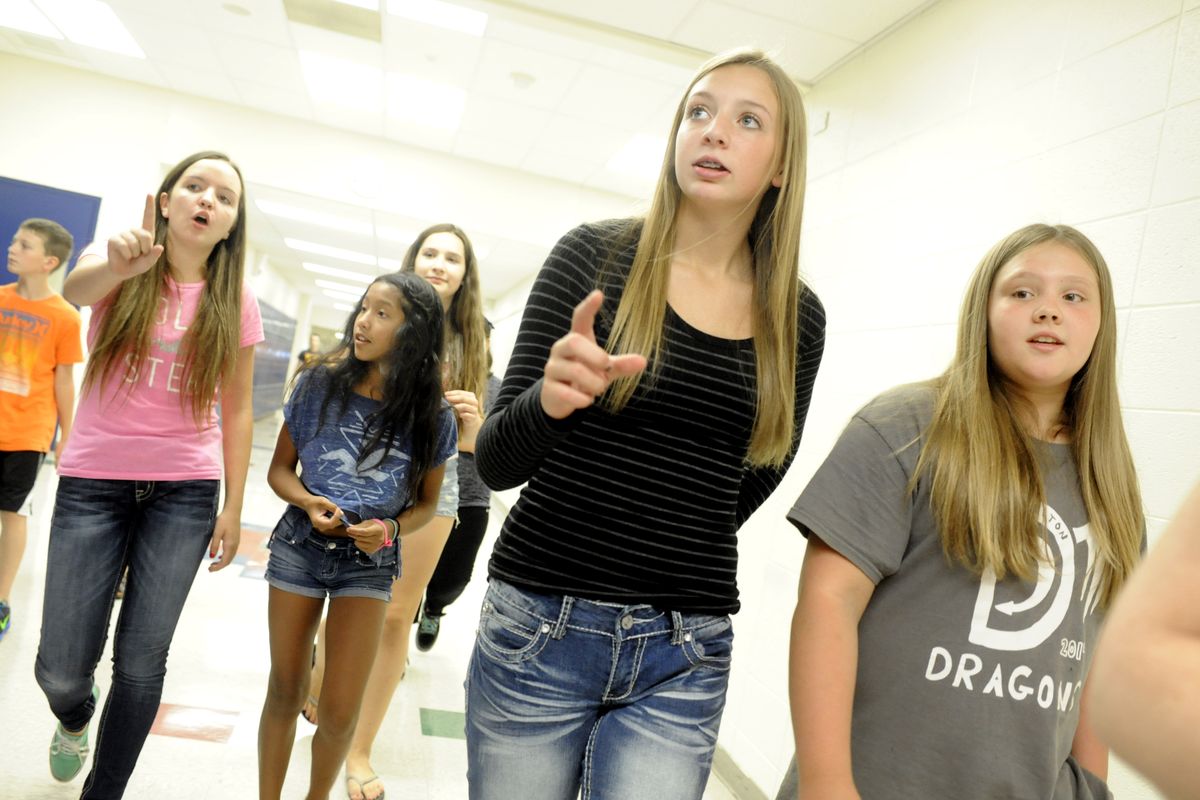 From left, eighth-grader Caroline Wade, sixth-grader Bella Dick, eighth-graders Olivia Haakenson and Kathryn Murray, and sixth-grader Alayna Louden take a tour of Canfield Middle School in Coeur d’Alene during sixth-grade orientation on Thursday. (Jesse Tinsley)