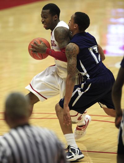 WSU’s Mike Ladd, left, drives against Jackson State in last week’s game at Pullman. (Associated Press)