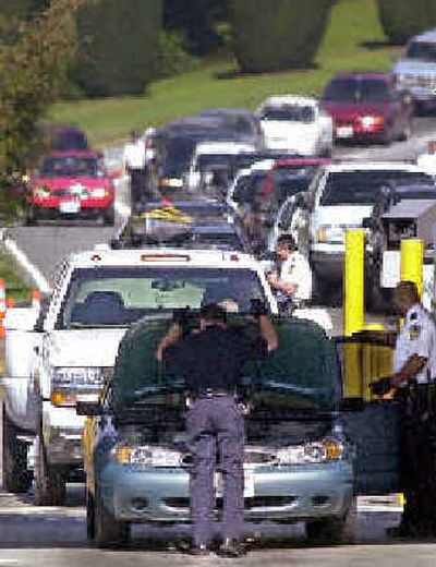 
Agents search a car entering the United States at the Peace Arch border crossing in Blaine, Wash., shortly after the attacks on Sept. 11, 2001. Security will be tightened by the end of the year to include fingerprinting of foreign visitors coming into the United States.
 (File/Associated Press / The Spokesman-Review)