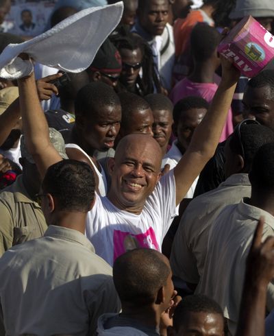 Michel Martelly greets people during a campaign rally in Port-au-Prince, Haiti, on Thursday.  (Associated Press)