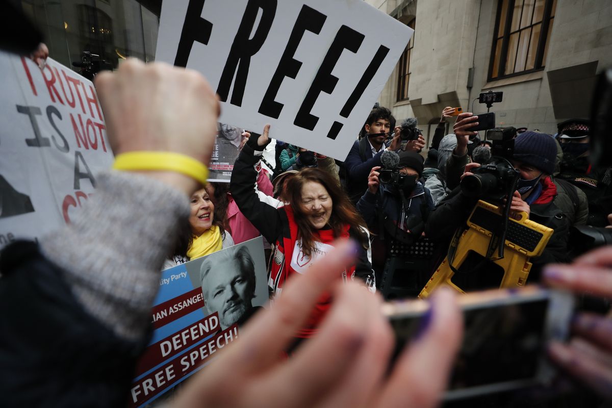 Julian Assange supporters celebrate after a ruling that he cannot be extradited to the United States, outside the Old Bailey in London, Monday, Jan. 4, 2021. A British judge has rejected the United States' request to extradite WikiLeaks founder Julian Assange to face espionage charges, saying it would be "oppressive" because of his mental health. District Judge Vanessa Baraitser said Assange was likely to commit suicide if sent to the U.S. The U.S. government said it would appeal the decision.  (Frank Augstein)