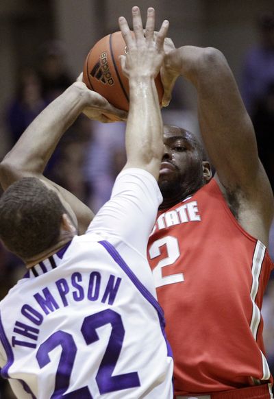Ohio State’s Dallas Lauderdale, right, looks to pass as Northwestern’s Michael Thompson defends during first-half play. (Associated Press)