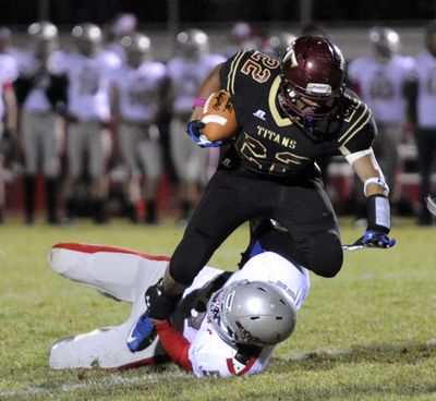 University’s Adrian Bonner (22) tries to carry the ball past Ferris defender Griffin Davis Oct. 19, at University High School. Bonner had touchdown runs of 27- and 15-yards, both in the fourth quarter. U-Hi won 21-0. (Jesse Tinsley)