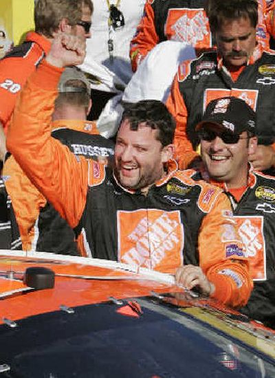 
Tony Stewart, left, celebrates in Victory Lane on Sunday. 
 (Associated Press / The Spokesman-Review)