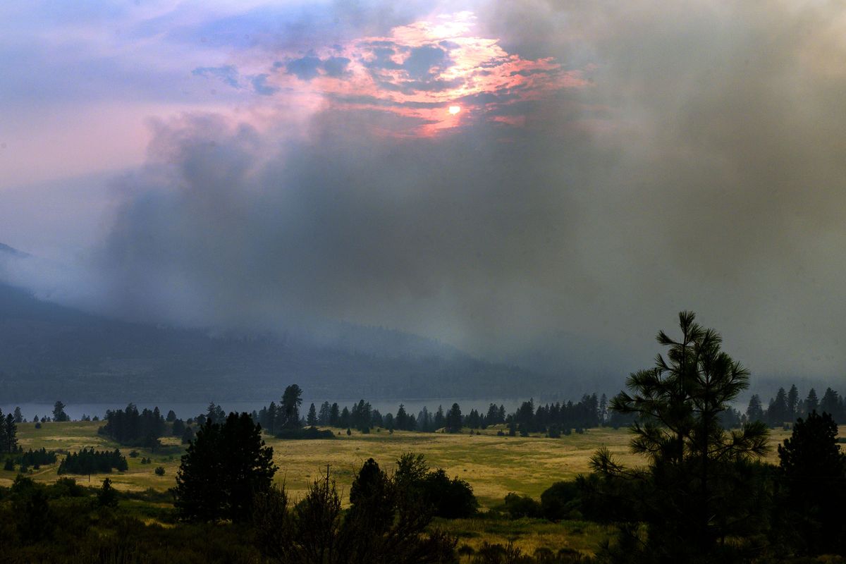 Along the Columbia River, the Williams Flats Fire burns on the Colville Indian Reservation, Thursday, Aug. 8, 2019. With cooler weather moving in over the weekend, firefighters hope to keep the blaze from crossing the river into Stevens County. (Colin Mulvany / The Spokesman-Review)