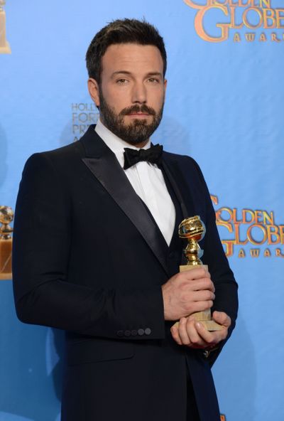 Ben Affleck poses with the Golden Globe best drama award for “Argo.” (Associated Press)