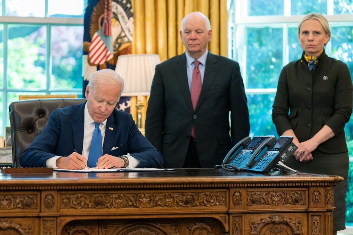 President Joe Biden signs the Ukraine Democracy Defense Lend-Lease Act of 2022 in the Oval Office of the White House, Monday, May 9, 2022, in Washington. Witnessing the signing are Ukraine-born Rep. Victoria Spartz, R-Ind., right, and Sen. Ben Cardin, D-Md.  (Manuel Balce Ceneta)