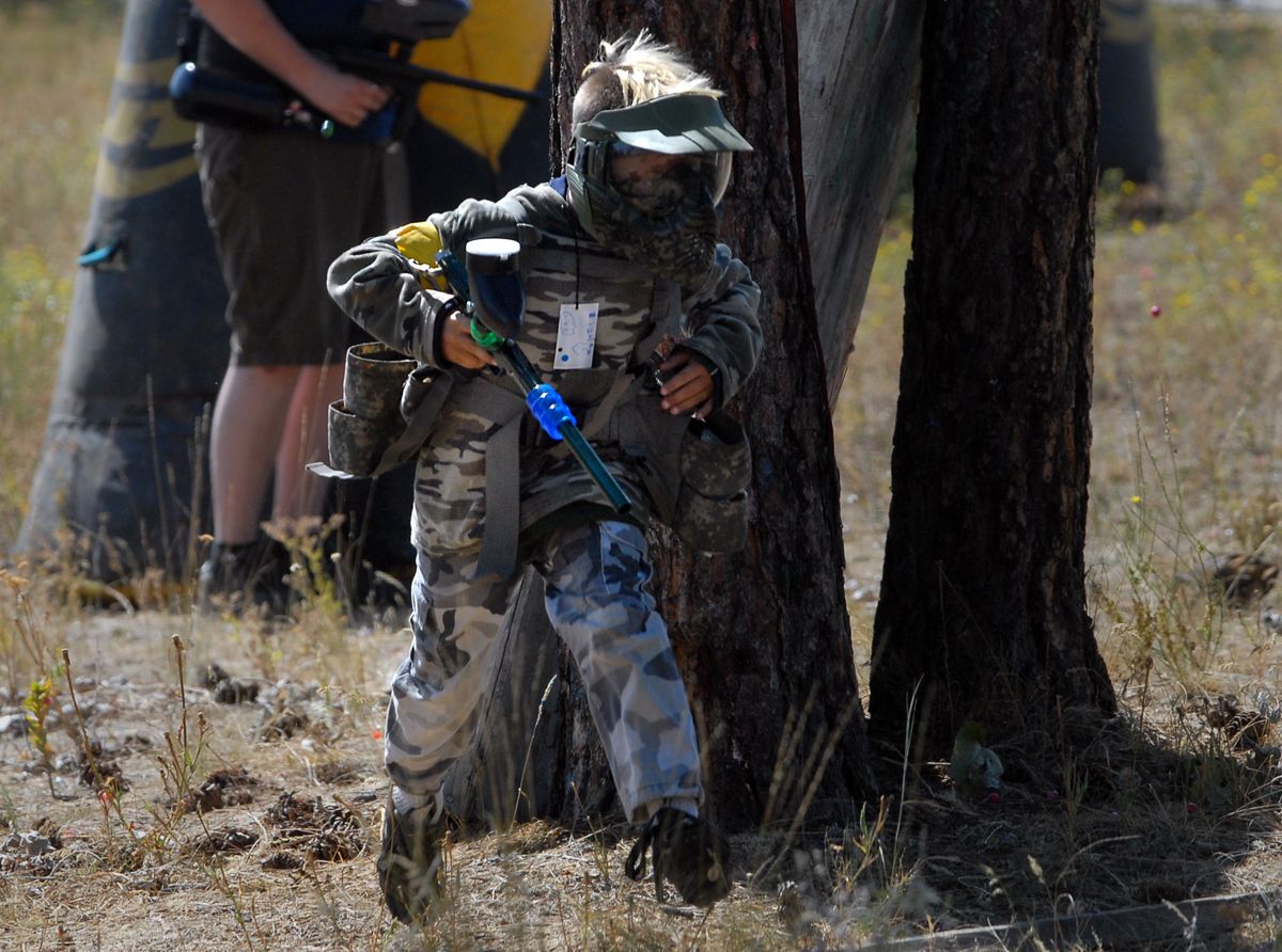 Darian Simonsen, 9, runs with members of the “attackers” group during a paintball event at Nitehawk Paintball. (Jesse Tinsley / The Spokesman-Review)