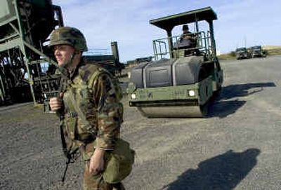 
Spc. Stuart Riddle, of Salt Lake City, escorts Spc. Chris Mason, of Boise, to a refueling truck Thursday at Fairchild Air Force Base. They are working at the base before going to  Iraq.
 (Colin Mulvany / The Spokesman-Review)