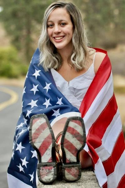 This senior picture of Sierra Athos was rejected for the Lewis and Clark High School yearbook. The high school said the flag is improperly displayed per U.S. code and serves as a prop.  (courtesy photo)