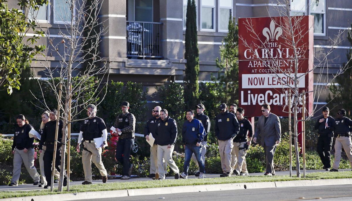 On March 3, 2015, federal agents enter an upscale apartment complex where authorities say a birth tourism business charged pregnant women $50,000 for lodging, food and transportation, in Irvine, Calif. On Thursday, Jan. 31, 2019, authorities announced they have charged 20 people in an unprecedented crackdown on businesses that helped hundreds of Chinese women travel to the United States to give birth to American citizen children. (Jae C. Hong / Associated Press)