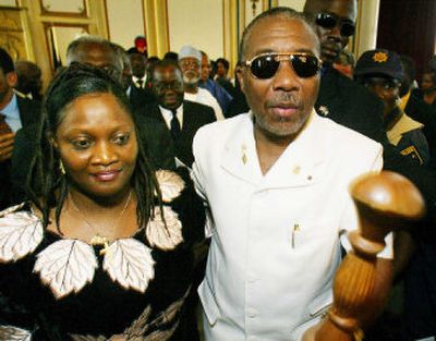 
Charles Taylor  and his wife, Jewel Howard-Taylor, leave  the executive mansion in Monrovia, Liberia, in  August  2003. 
 (File Associated Press / The Spokesman-Review)