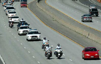 
A motorcade of Washington State Patrol and area police escorts Mike Kralicek part of the way to his Coeur d'Alene home on Wednesday. 
 (Joe Barrentine / The Spokesman-Review)