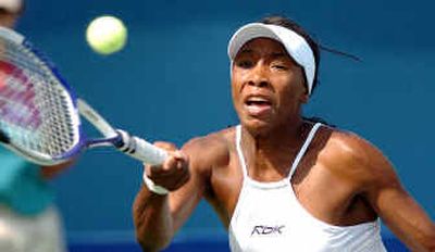 Venus Williams returns a shot back to Els Callens of Belgium during Fed Cup match in Delray Beach, Fla., on Saturday.
(Associated Press / The Spokesman-Review)