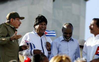 
Cuba's acting president, Raul Castro, left, talks with Bolivian President Evo Morales, Haitian President Rene Preval, and Nicaraguan President-elect Daniel Ortega during a parade  Saturday. 
 (Associated Press / The Spokesman-Review)