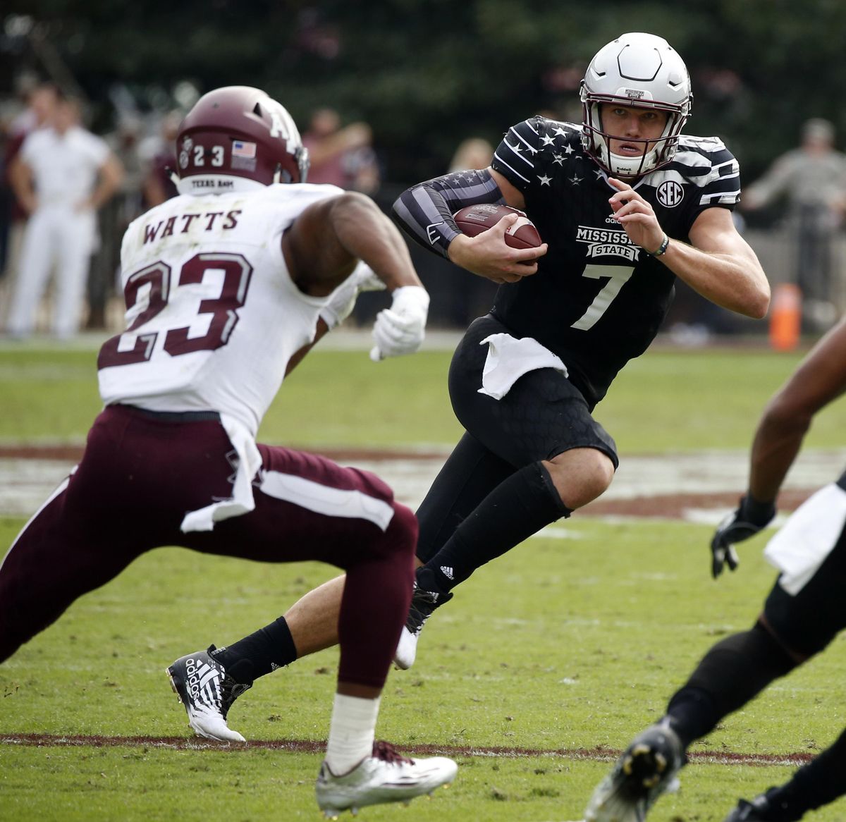 Mississippi State’s quarterback Nick Fitzgerald runs past Texas A&M’s Armani Watts for a first down. (Rogelio V. Solis / Associated Press)