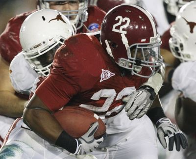Alabama running back Mark Ingram (22) breaks a tackle by Texas defensive end Sam Acho during the third quarter of the  BCS Championship NCAA college football game in Pasadena. (AP Photo/) (Marcio Jose Sanchez / The Associated Press)