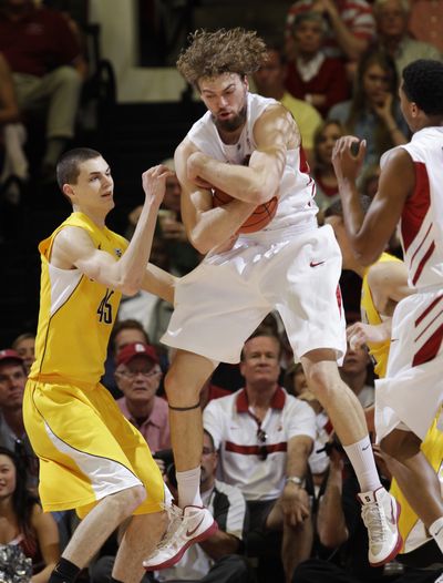 Andrew Zimmermann, with ball, and Stanford denied David Kravish and Cal share of Pacific-12 title. (Associated Press)