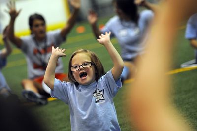 Meggie Lloyd, 6, stretches out after soccer practice with her teammates at TOPSoccer, a program for children with physical and intellectual disabilities.  (Photos by RAJAH BOSE / The Spokesman-Review)