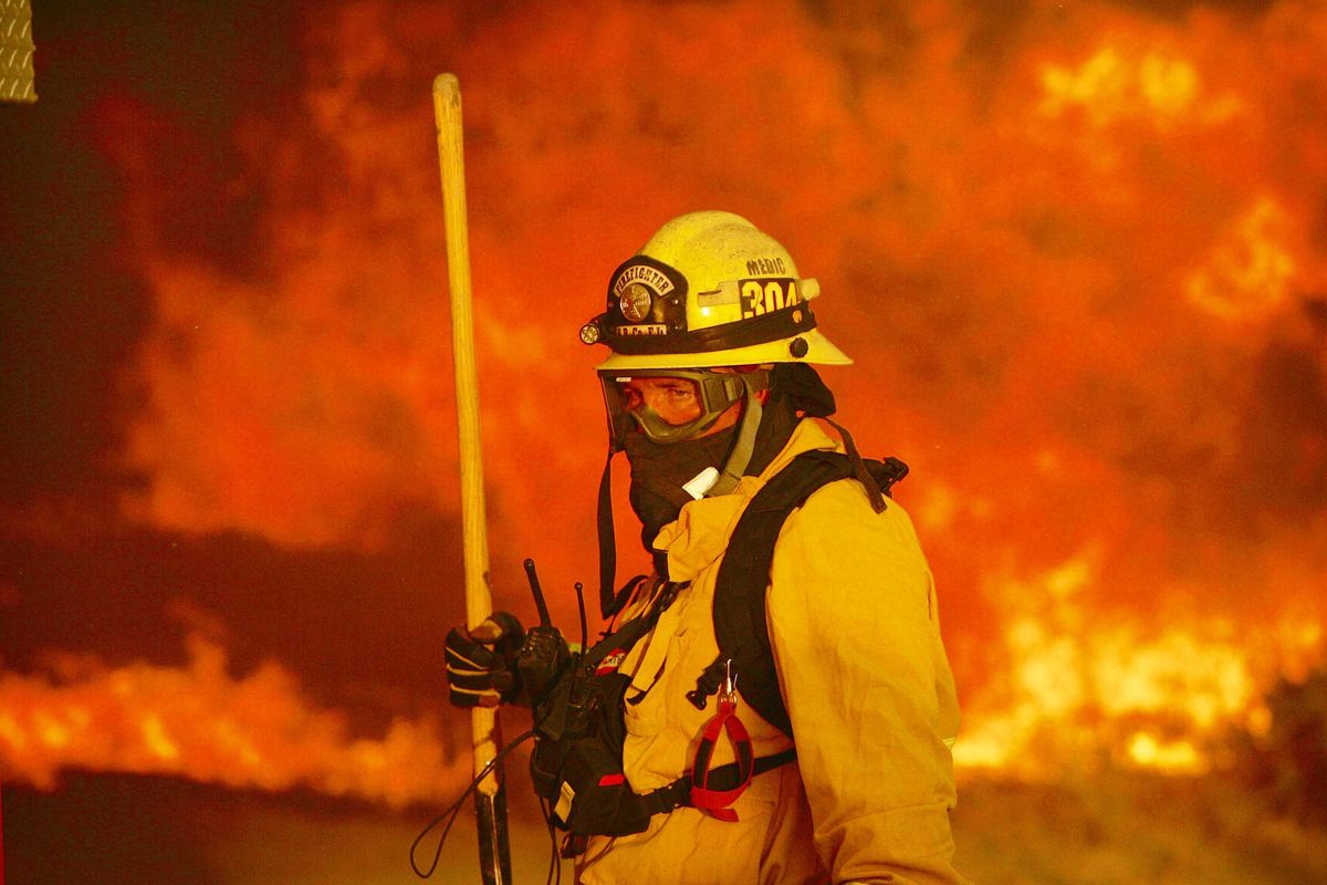 A firefighter prepares to battle a wildfire in the Cajon Pass in San Bernardino county, Calif., on Tuesday, Aug. 16, 2016. (Stan Lim / Press-Enterprise via Associated Press)