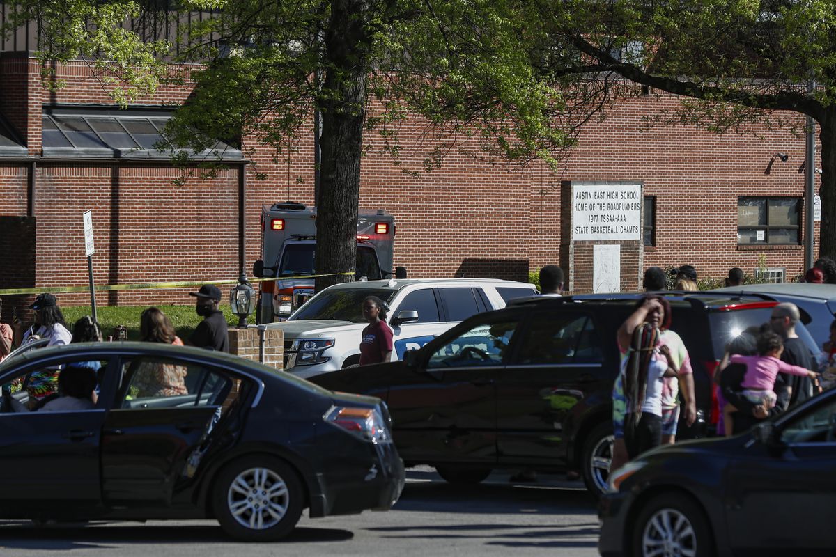 People gather outside Austin East High School in Knoxville, Tenn., as Knoxville police work the scene following a shooting at the school Monday, April 12, 2021.  (Wade Payne)