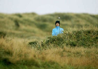 
Michelle Wie watches her shot after hitting out of the rough on the fourth hole at the Women's British Open on Thursday.
 (Associated Press / The Spokesman-Review)