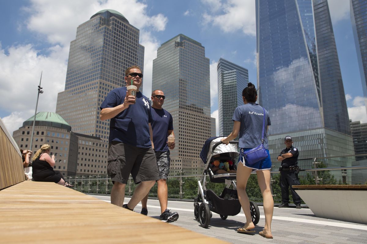 Visitors stroll through Liberty Park, Wednesday, June 29, 2016, in New York. The one-acre, elevated Liberty Park opened to the public Wednesday. Built on top of a security center, it overlooks the memorial to those who died in the Sept. 11 attacks. (Mary Altaffer / Associated Press)