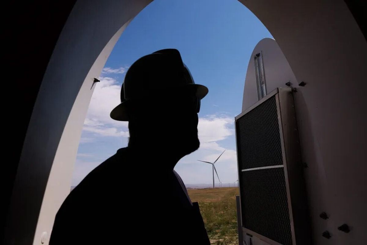 Kyle Sullivan, now the plant manager at the Beaver Creek wind farm in Stillwater County, Montana, stands within the base of a wind turbine last summer. The 248-megawatt project, owned by Puget Sound Energy, came online in August and cost the utility $530 million.  (Erika Schultz/Seattle Times)