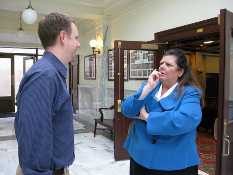 New Idaho redistricting commissioner Lorna Finman of Rathdrum, right, visits with Idaho GOP Executive Director Jonathan Parker, left, during a break in the commission's first meeting on Tuesday. (Betsy Russell)